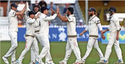  ?? Picture: Michael Steele/Getty ?? Zahar Gohar, third right, celebrates his dismissal of Durham’s Paul Coughlin