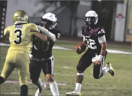  ?? PHOTO AARON BODUS ?? Calexico quarterbac­k Abram Zazueta looks for running room against the Vincent Memorial defense Friday night.