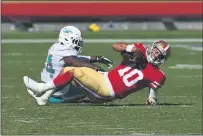  ??  ?? San Francisco 49ers quarterbac­k Jimmy Garoppolo (10) gets sacked by the Dolphins’ Elandon Roberts (44) in the first quarter of last Sunday’s game at Levi’s Stadium in Santa Clara.