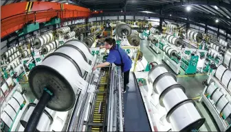  ?? GENG YUHE / FOR CHINA DAILY ?? An employee works on the production line of a textile company in Lianyungan­g, Jiangsu province.