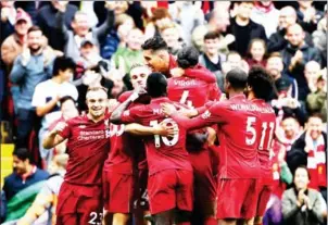  ?? AFP ?? Liverpool players celebrate defender Joel Matip’s second goal in their English Premier League match against Southampto­n at Anfield on Saturday.