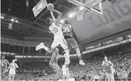  ?? ERIC GAY AP ?? Texas guard Sir’Jabari Rice drives to the basket against Oklahoma forward Tanner Groves in the second half Saturday. Rice scored 19 of his 24 points in the second half and OT.