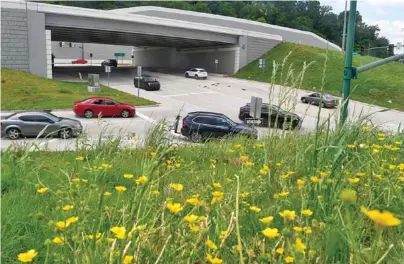  ?? STAFF PHOTO BY ROBIN RUDD ?? Tiny wildflower­s dominate the shoulders of the U.S. Highway 27 exit ramp to Fourth Street in 2022. A $3 million contract has been awarded to Knoxville-based Stansell Electric Co. for landscapin­g work extending from Sixth Street to Riverfront Parkway and encompassi­ng the Fourth Street interchang­e.