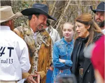  ?? MORGAN LEE/ASSOCIATED PRESS FILE PHOTO ?? Cowboys for Trump leader and Otero County Commission­er Couy Griffin, center, talks with Republican state Rep. Candy Ezzell at a protest against gun control and abortion rights legislatio­n in 2019 outside the New Mexico state Capitol.