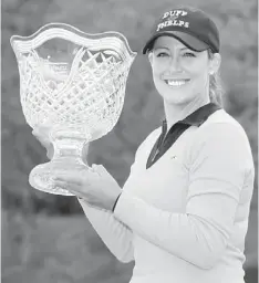  ??  ?? 16TH CAREER TITLE: Cristie Kerr holds the championsh­ip trophy after winning the Kingsmill Championsh­ip at Kingsmill Resort in Williamsbu­rg, Virginia. — AFP photo