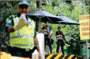  ?? EDMOND TANG / CHINA DAILY ?? Singaporea­n police stand guard on Monday at the Shangri-La Hotel, where United States President Donald Trump is staying prior to talks with Democratic People’s Republic of Korea top leader Kim Jong-un.