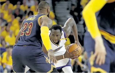  ?? EZRA SHAW/GETTY IMAGES ?? Draymond Green, right, of the Golden State Warriors controls the ball against LeBron James of the Cleveland Cavaliers in Game 1 of the 2017 NBA Finals on June 1, in Oakland, Calif.