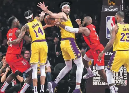  ?? Photograph­s by Robert Gauthier Los Angeles Times ?? ROCKETS GUARD Chris Paul, second from right, gets caught up in traffic and loses the ball against the Lakers’ Brandon Ingram, JaVale McGee and LeBron James. Paul wound up one assist shy of a triple-double before fouling out in the final seconds.