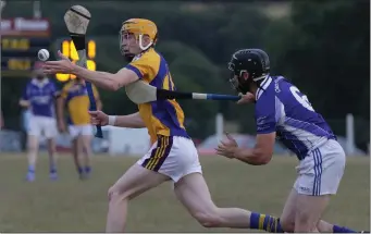  ??  ?? Stephen O’Gorman (Taghmon-Camross) keeps the ball away from Liam Kinsella (Our Lady’s Island) in the Top Oil IAHC game in Hollymount on Saturday.