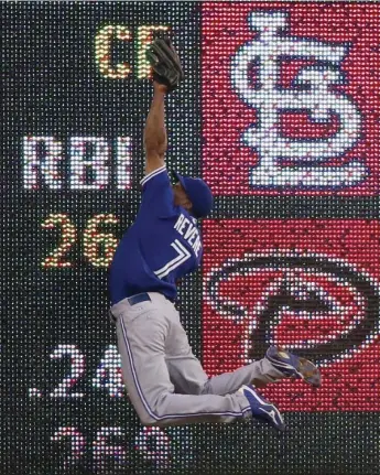  ?? TONY GUTIERREZ/THE ASSOCIATED PRESS ?? The Blue Jays’ Ben Revere makes an acrobatic catch against the Rangers. Go to thestar.com for game results.