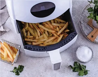  ?? Picture: GETTY ?? TASTY SAVINGS: Energy bills can be slashed if you use an air fryer instead of a fan-assisted oven