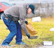  ?? JOHN P. CLEARY /THE HERALD-BULLETIN/ AP ?? In January, Elwood, Ind., police bag evidence as they investigat­e an armed robbery at Low Cost Prescripti­ons in which police shot and wounded one robbery suspect.