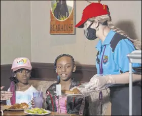  ?? Ellen Schmidt Las Vegas Review-Journal @ellenkschm­idt_ ?? Employees are required to wear masks at John’s Incredible Pizza. The Las Vegas outlet at The Boulevard was the 14-restaurant company’s first to reopen, on June 8.