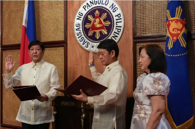  ?? PHOTOGRAPH COURTESY OF PRESIDENTI­AL COMMUNICAT­IONS OFFICE ?? FORMER Interior Secretary Eduardo Año returns to government service as National Security Adviser. President Ferdinand ‘Bongbong’ Marcos jr. (left) administer­s the oath of office of Año yesterday. Also in photo is Año’s wife Jean Joselyn Maria.