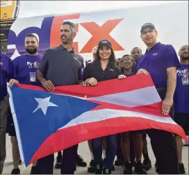  ?? JOSHUA REPLOGLE / ASSOCIATED PRESS ?? Former New York Yankees catcher Jorge Posada and his wife, Laura, pose for a photo after donating 155,000 pounds of food to be delivered to Puerto Rico, still recovering from Hurricane Maria, where Posada is from, on Monday.