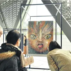  ??  ?? Onlookers gaze at an official Olympic and Paralympic poster titled Wild Things – Hachilympi­c at the Museum of Contempora­ry Art Tokyo.