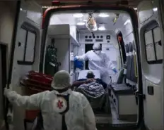  ?? Felipe Dana/Associated Press ?? Mobile Emergency Care Service technician­s move a COVID19 patient to an ambulance as he is transferre­d to a municipal hospital dedicated to COVID-19 in Duque de Caxias, Rio de Janeiro state, Brazil, on Tuesday.