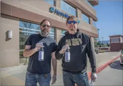  ?? Signal file photo ?? Billy, left, and David, right, Vondrasek hold bottles of hand sanitizer donated to Henry Mayo Newhall Hospital by Azeo Distillery in March. The brothers donated hundreds of boxes of the sanitizer up and down the coast. In December, they recived notice from the FDA that they owed nearly $23,500 in fees, but those fees have since been struck down.