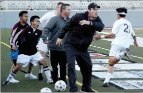  ?? Graham Thomas/Siloam Sunday ?? Siloam Springs coaches Luke Shoemaker and Brent Crenshaw and soccer players congratula­te Christian Marroquin after he scored in the 15th minute to give Siloam Springs a 2-1 lead against Benton in the 6A-West Conference Tournament semifinals at Panther...