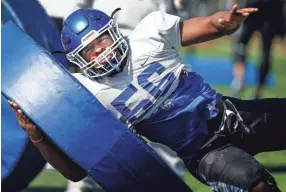  ??  ?? University of Memphis offense lineman Dylan Parham runs through drills during a recent Tigers spring practice. MARK WEBER/THE COMMERCIAL APPEAL