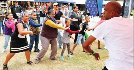  ?? Picture: Phando Jikelo/ANA ?? WORKING OUT: A Hercules boot camp official takes some who attended the Mitchells Plain festival through their paces, doing aerobics with them.