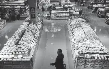  ?? NATHAN DENETTE THE CANADIAN PRESS ?? Customers shop in the produce area at a Loblaws store in Toronto.