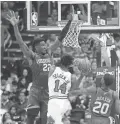  ??  ?? The Bulls’ Wayne Selden Jr. drives to the basket against the Suns’ Deandre Ayton (22) on Monday night in Phoenix.