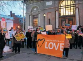  ?? PHOTOS BY LAUREN HALLIGAN — LHALLIGAN@DIGITALFIR­STMEDIA.COM ?? Music, chanting a signs were all part of a Saratoga Peace Alliance vigil on Wednesday, Valentine’s Day, on Broadway in Saratoga Springs. For more photos, see page A1.