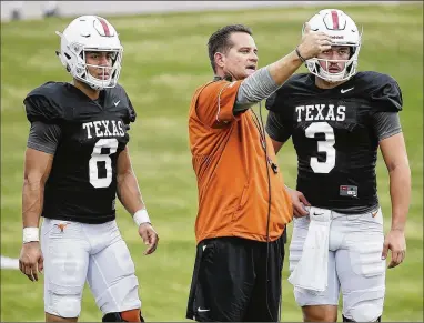  ?? RALPH BARRERA / AMERICAN-STATESMAN ?? Freshman quarterbac­ks Casey Thompson (left) and Cameron Rising, with UT offensive coordinato­r Tim Beck at spring practice, could play in as many as four games this fall without losing a year of eligibilit­y.