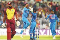  ?? AFP ?? Left-arm spinner Krunal Pandya (second from left) celebrates after taking his maiden wicket against West Indies.