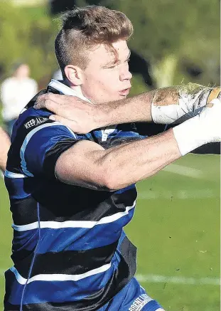  ??  ?? Hand off . . . Taieri flanker Josh Brown attempts to fend off Kaikorai fullback Ben Miller at Bishopscou­rt on Saturday.