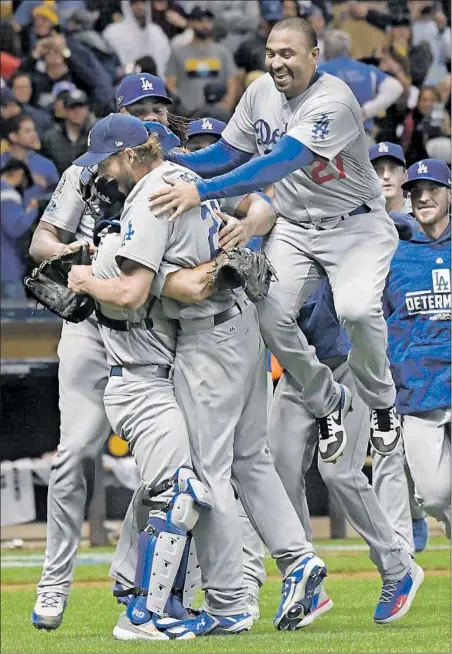  ?? Wally Skalij Los Angeles Times ?? DODGERS PLAYERS, including Matt Kemp (jumping) are overjoyed after Clayton Kershaw, front left, secured the victory.