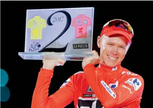  ?? AP file ?? Chris Froome celebrates on podium after winning the Spanish Vuelta cycling race in Madrid. —