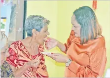  ?? Picture: JONACANI LALAKOBAU ?? Minister for Women, Children and Poverty Alleviatio­n Rosy Akbar feeds cake to Sheela Wati, 89, during the celebratio­ns.