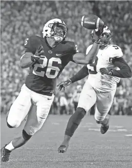  ?? CHRIS KNIGHT/AP ?? Penn State’s Saquon Barkley (26) gains control of a pass and takes it in for a touchdown against Michigan during the second half Saturday in State College, Pa.