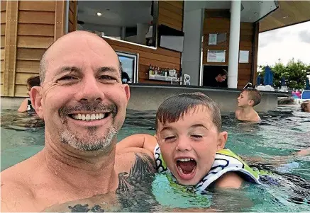  ?? SUPPLIED ?? Simon Clark, 48, died on Thursday as a result of a crash on State Highway 3, north of New Plymouth, on August 10. He leaves behind his sons George Clark (right), four, and Charlie Clark (background), eight.