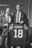  ??  ?? Colts owner Jim Irsay, left, poses with former Colts quarterbac­k Peyton Manning after announcing the retirement of Manning’s jersey during a press conference Friday in Indianapol­is.