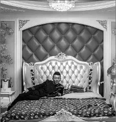  ??  ?? Brother Li, founder of the live-streaming agency Wudi Media, poses in his bedroom in Shenyang.