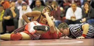  ?? NATE HECKENBERG­ER — DIGITAL FIRST MEDIA ?? Church Farm’s Yunbue Tanco fights off Bristol’s Ryan Biggio for a pin at 152 pounds.