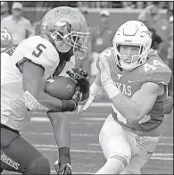  ?? AP/MICHAEL THOMAS ?? Oklahoma State running back Justice Hill (5) tries to run past Texas linebacker Breckyn Hager during the No. 10 Cowboys’ 13-10 overtime victory over the Longhorns on Saturday in Austin, Texas. Hill ran for 117 yards on 33 carries in the victory.