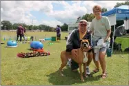  ?? LAUREN HALLIGAN - MEDIANEWS GROUP ?? Six-year-old Boxer Holly Noel, with Pat and Jane Burns of Scotia, enjoy the sixth annual Help A Dog BBQ & Pet Festival on Sunday afternoon at the Albany-Saratoga Speedway in Malta.