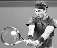  ??  ?? Nadal hits a return during his men’s third round singles match against Fabio Fognini at the Shanghai Masters tennis tournament in Shanghai. — AFP photo