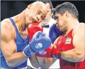  ??  ?? England's Frazer Clarke (L) fights India's Satish Kumar during their men's +91kg final during the 2018 Commonweal­th Games.