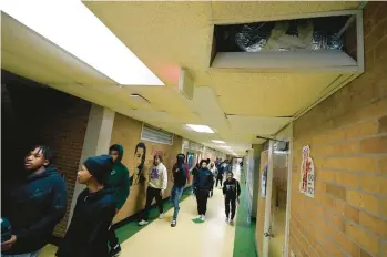  ?? ROGELIO V. SOLIS/AP ?? Jim Hill High School students walk past an open vent of the school’s HVAC system Jan. 12 in Jackson, Miss.