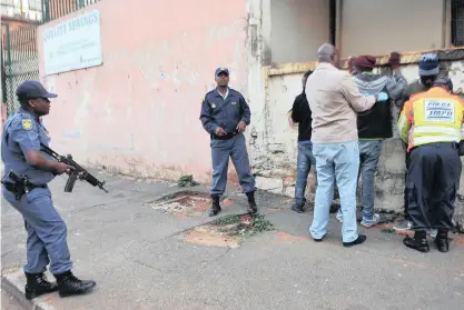  ?? PICTURES: ITUMELENG ENGLISH ?? WRONG PAPER: Three men are arrested for not having the correct documentat­ion during a raid in Doornfonte­in, Joburg on Friday.