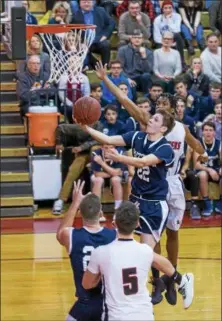  ?? DENNIS KRUMANOCKE­R - FOR DIGITAL FIRST MEDIA ?? Kutztown’s Dane Fegely drives over Schuylkill Valley’s Nathaniel Solomon for a basket.