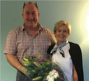  ??  ?? Clare Storey is presented with flowers by retiring Club Chairperso­n Michael O’Hehir, as she retires from the role of Sligo RFC Secretary.