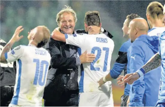  ??  ?? Slovakia head coach Jan Kozak celebrates with his team after the Euro 2016 qualifying victory over Spain