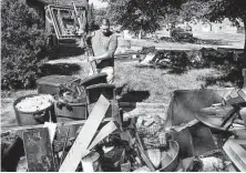  ?? Craig Ruttle / Associated Press ?? Josh Herrera places destroyed items on the lawn of his home in Millburn, N.J., after flash flooding from the remnants of Ida.