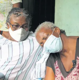  ?? NATHANIEL STEWART/ PHOTOGRAPH­ER ?? Mom Lorna Ellis (left) and aunt Janette Reid comfort each other yesterday as they grieve the death of Renford ‘Hector’ Mowen, of Ballards River in Clarendon, who died in a crash on Tuesday.